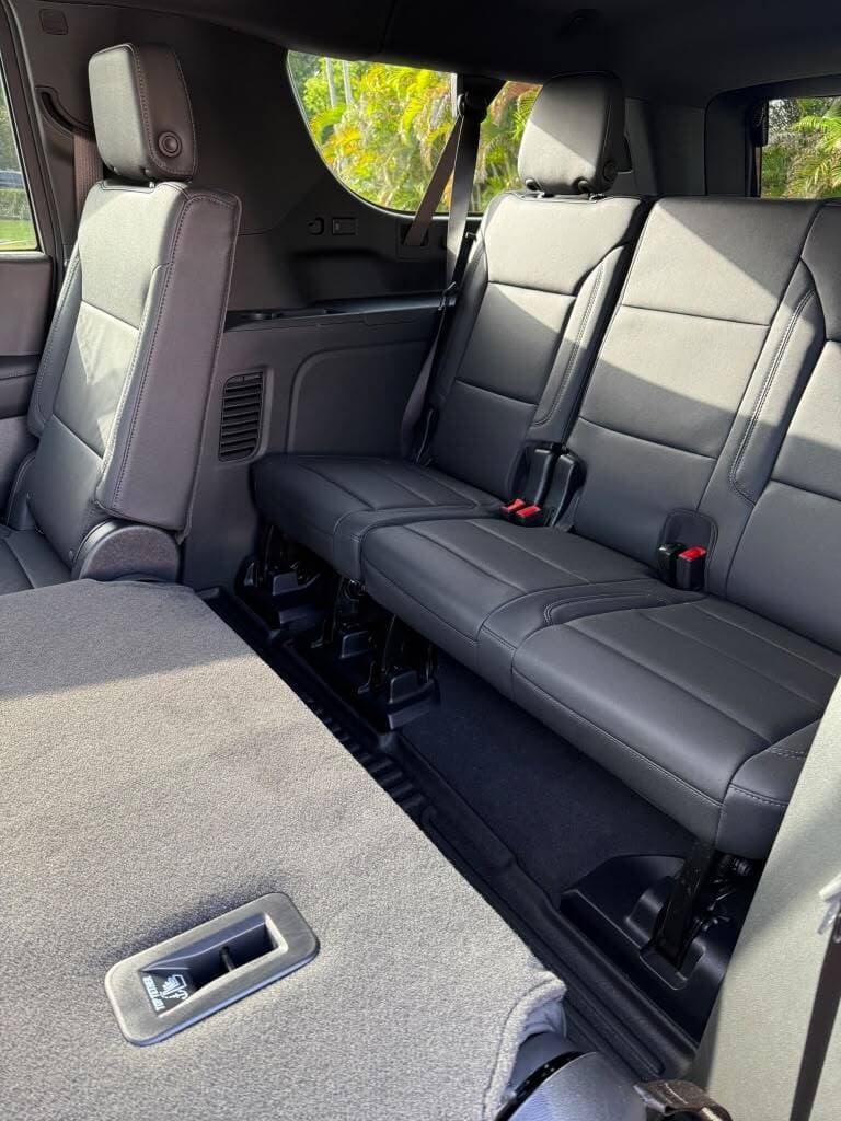 Third-row bench seating inside a black Chevrolet Suburban, ready for a pickup in Hialeah